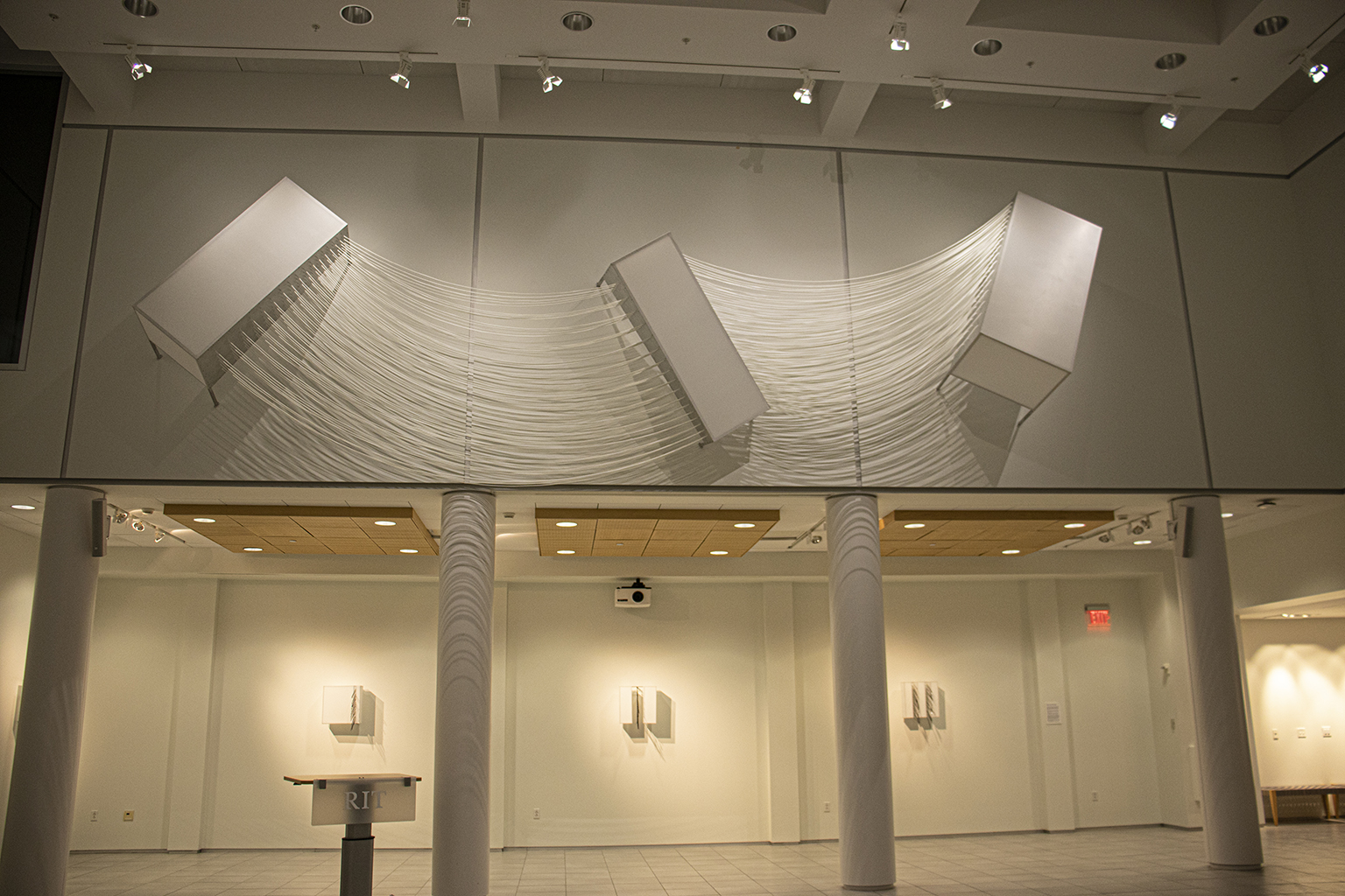 Linear Compression #231’ across; 8’drop with cords;each geometric 6’ h;farthest extension off wall 42”